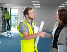 an image of two people shaking hands in a business setting
