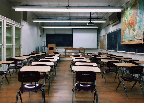 an image of a classroom with many, single desks and a light suspended ceiling