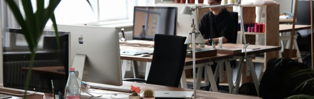 image of an office with people working