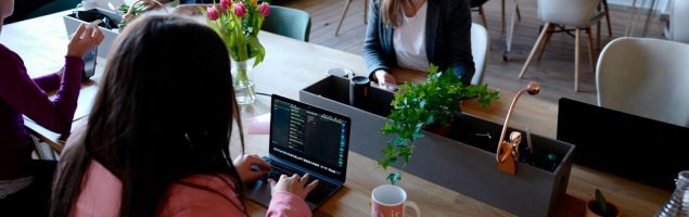 image of three women sitting on the chair using their laptops